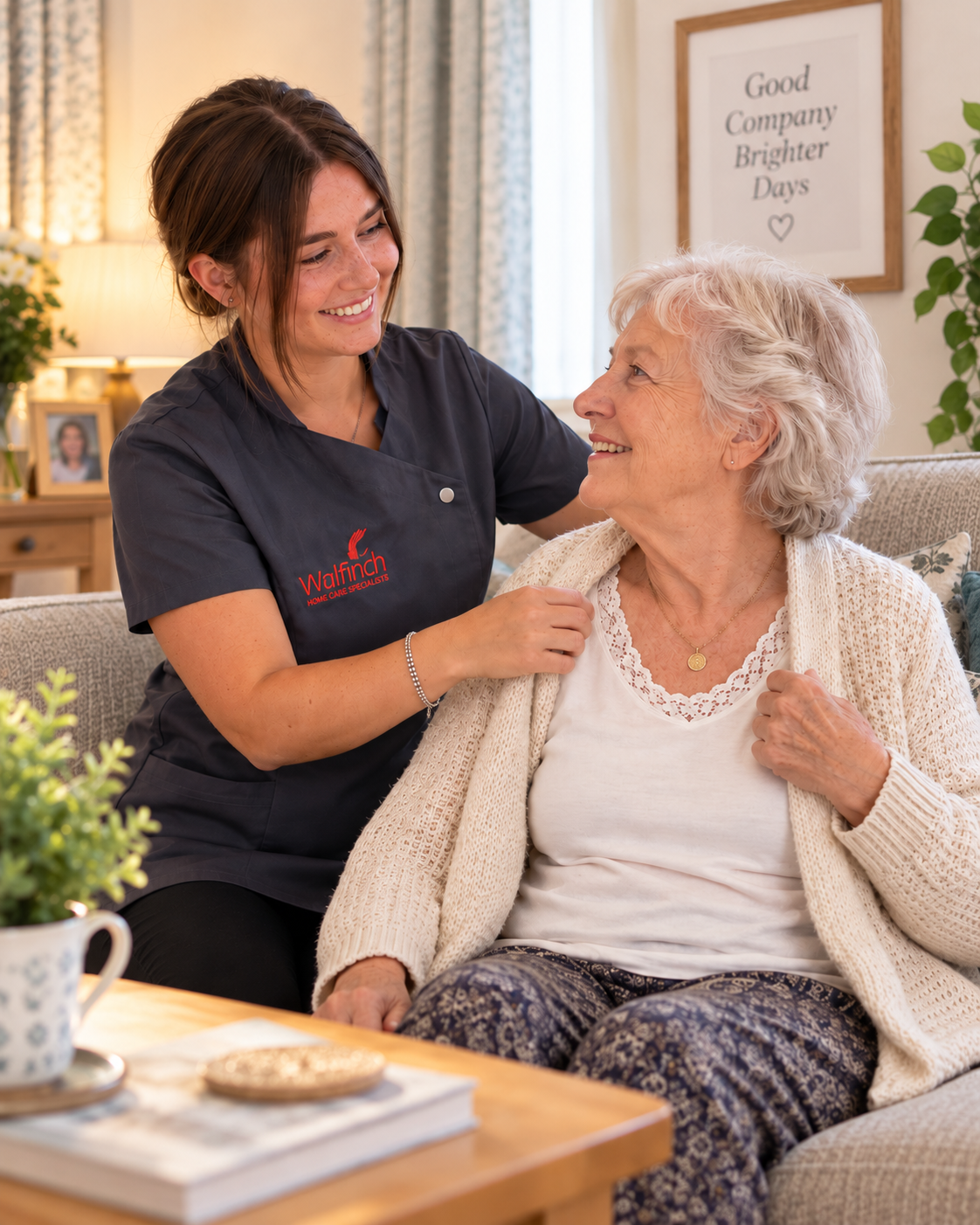 A Walfinch Newcastle carer helping an older client with her cardigan at home