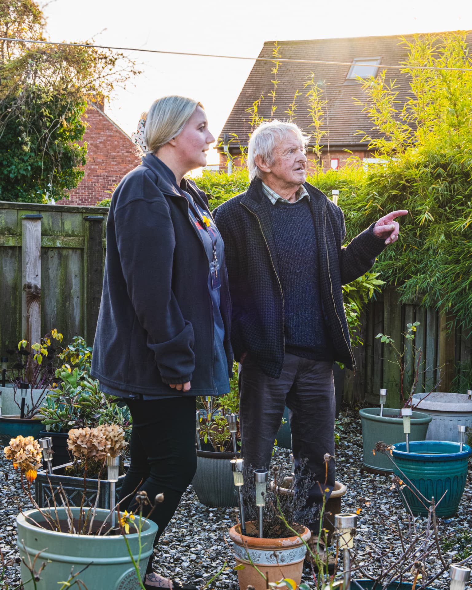 A Walfinch Newcastle carer and an older client looking out over the garden together