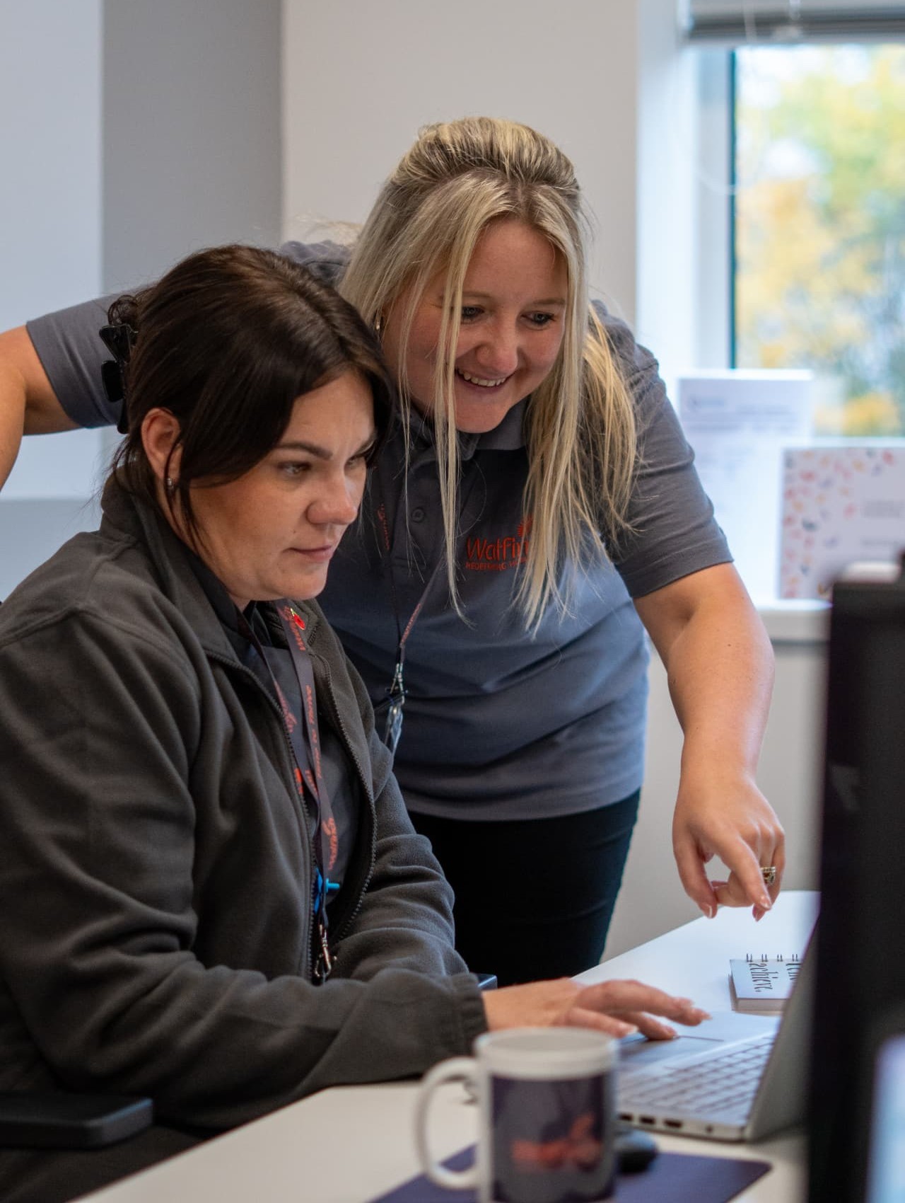 Two members of the Walfinch Newcastle office team working together at a desk