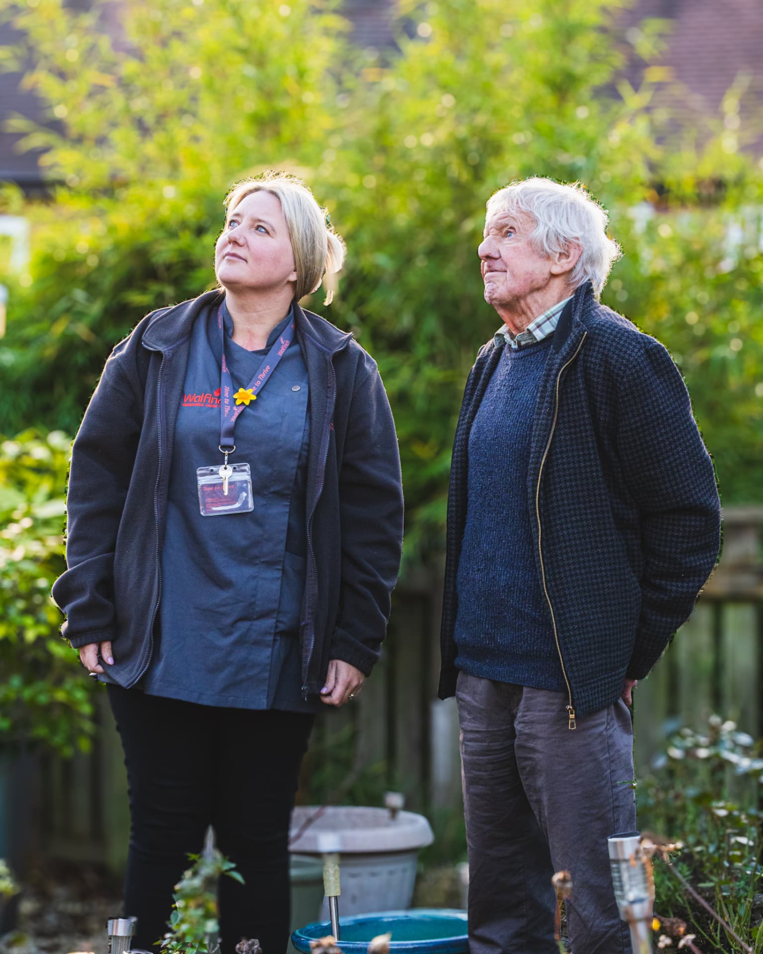 A Walfinch Newcastle carer standing with an older client in his garden
